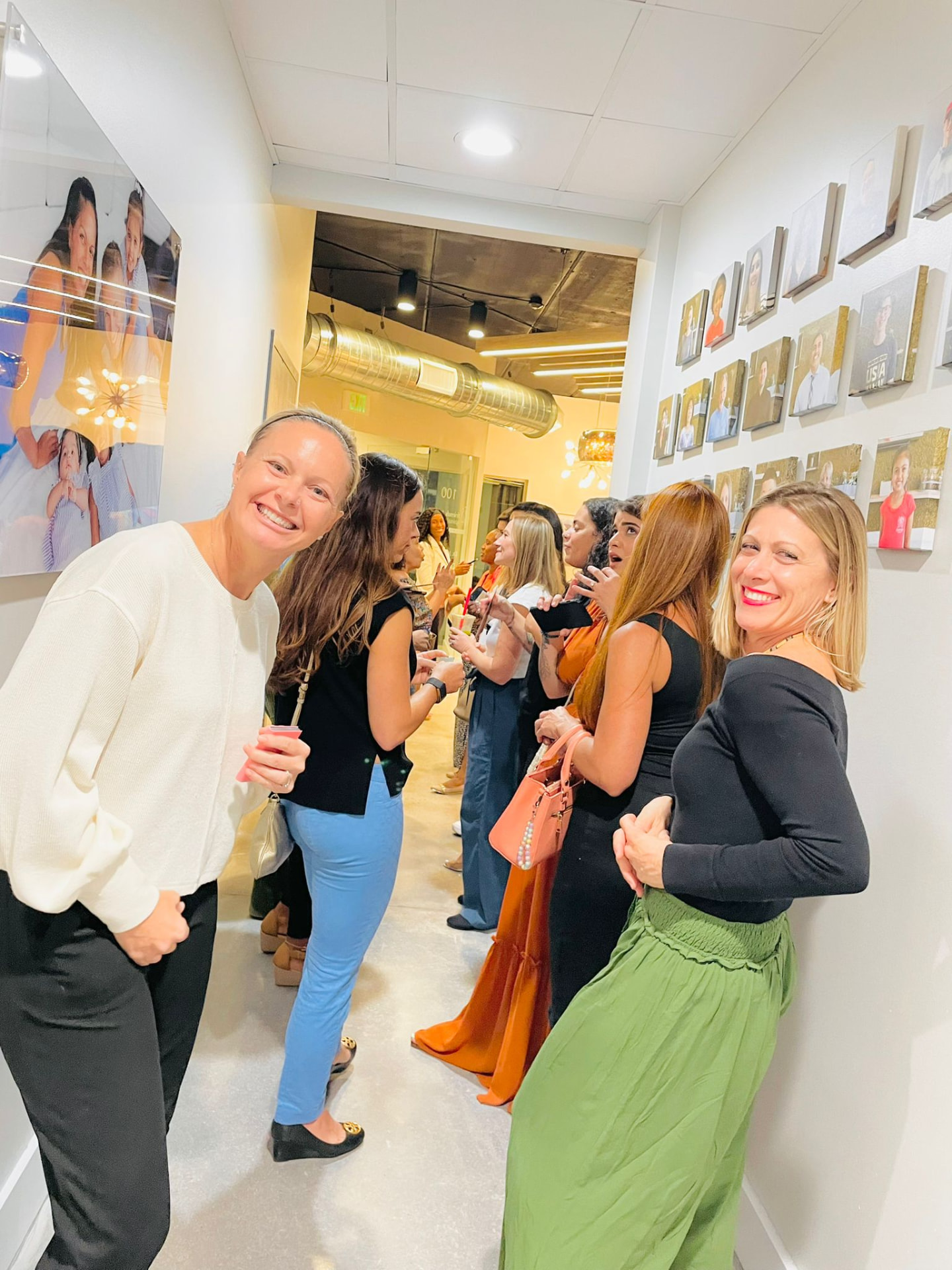 HBN members smiling together in a hallway at an HBN event