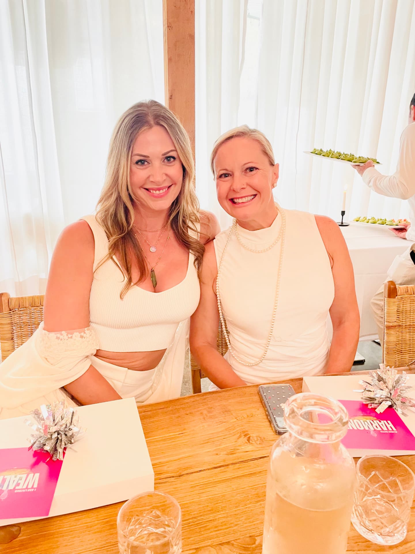 Two HBN members in conversation at an event table